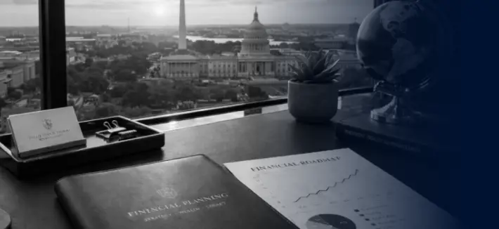 photo of top of desk in front of window with a view of Capital Hill